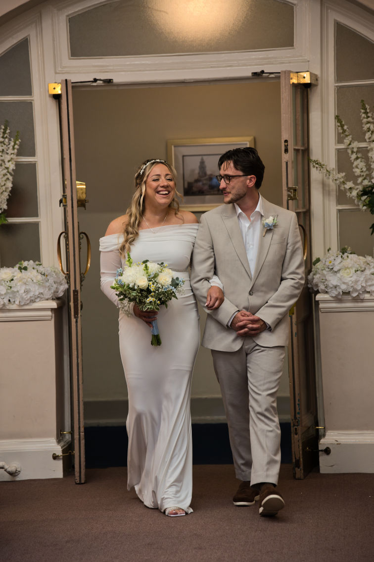 A bride walking down the aisle and being given away by her brother