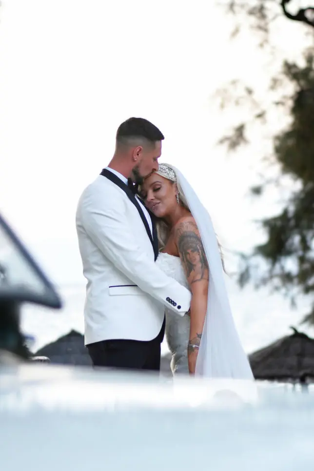 bride and groom near their wedding car 