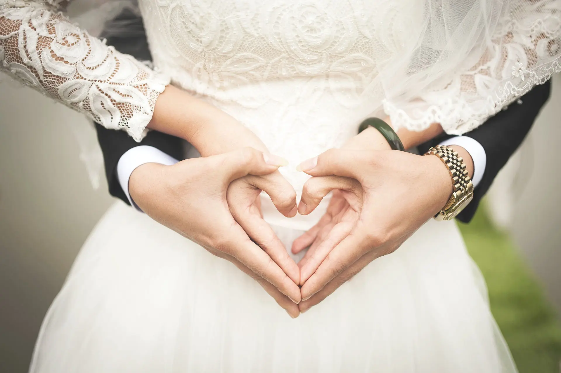 Bride and groom make a love sign taken by JPH photography