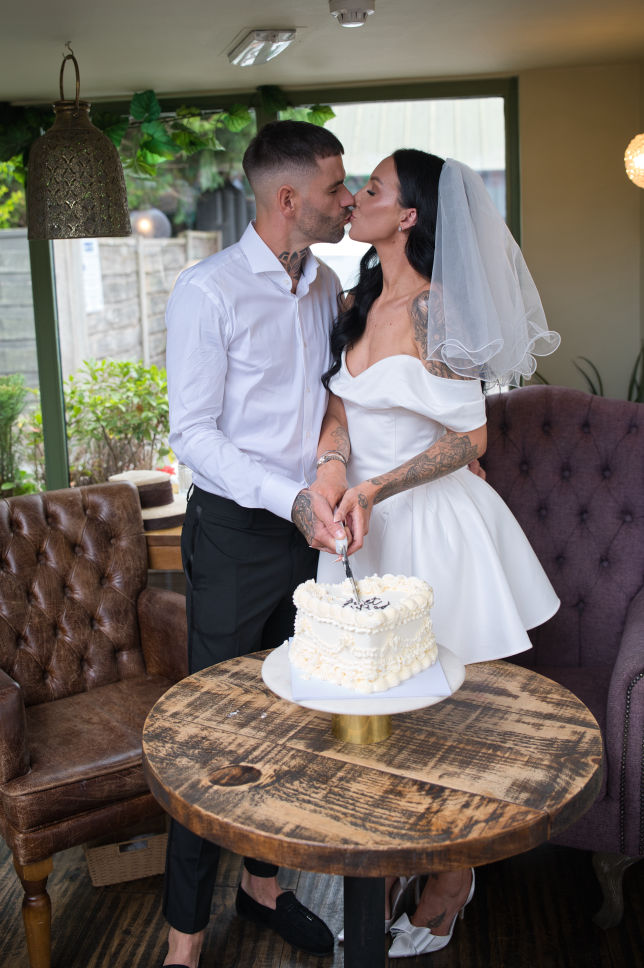 bride and groom cutting the cake 