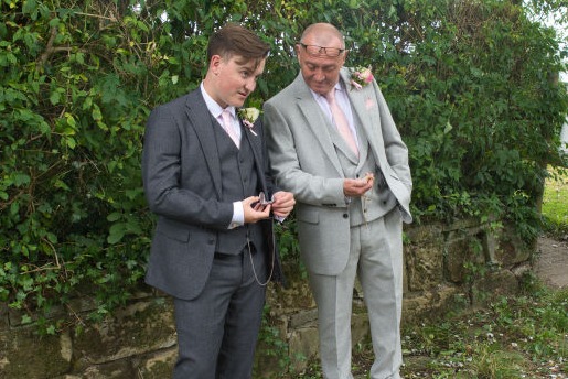The groom and the best man checked their watches as the bride is fashionably late at the lime breeze wedding venue, Macclesfield.